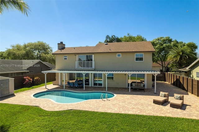 view of swimming pool featuring a fenced in pool, a fenced backyard, a pergola, a patio area, and a lawn