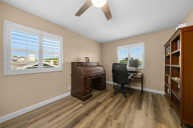 office space with wood finished floors, baseboards, and ceiling fan