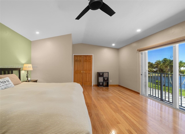 bedroom with light wood-style flooring, multiple windows, access to exterior, and vaulted ceiling