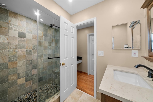 full bathroom with tile patterned floors, a stall shower, and vanity