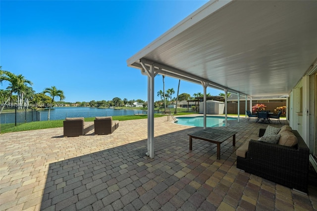 view of patio / terrace with a water view, an outbuilding, and a shed