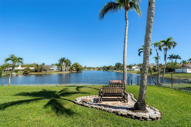 exterior space with a water view and fence