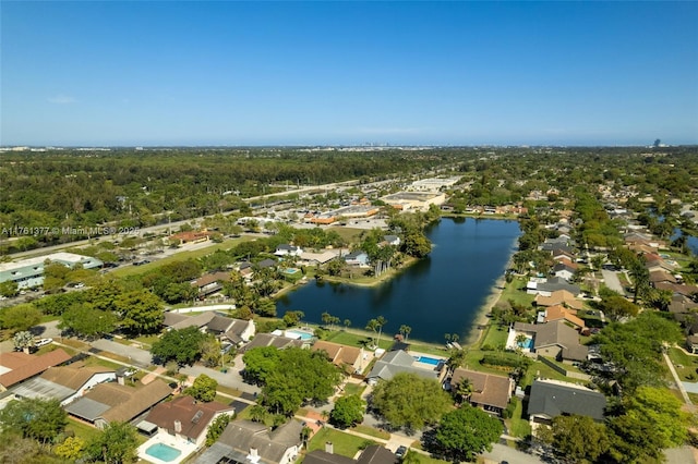 drone / aerial view with a residential view and a water view