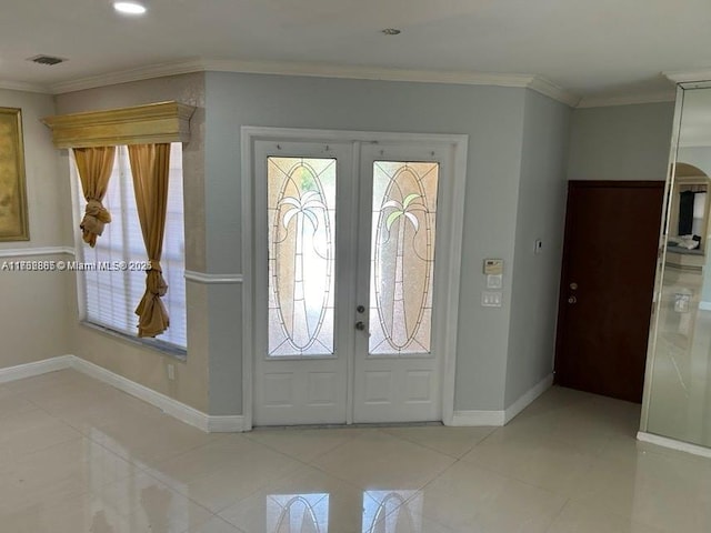 tiled entryway featuring french doors, a healthy amount of sunlight, crown molding, and visible vents