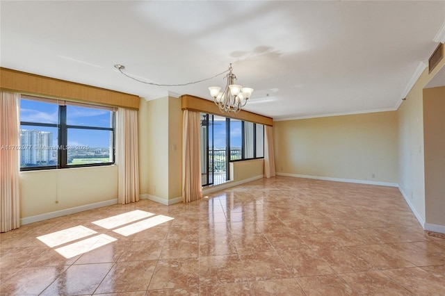 empty room featuring baseboards, a notable chandelier, and crown molding