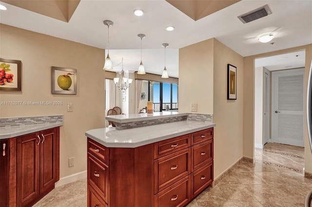 kitchen with decorative backsplash, light countertops, visible vents, and reddish brown cabinets