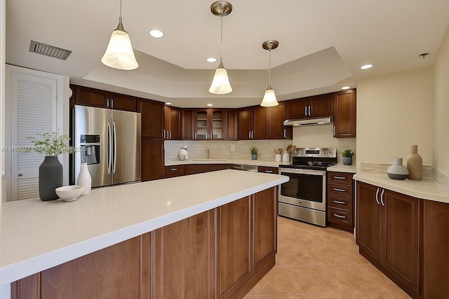 300 Three Islands Blvd Unit 518, Hallandale Beach, FL 33009 - kitchen with appliances with stainless steel finishes, light tile patterned floors, light countertops, glass insert cabinets, and decorative backsplash