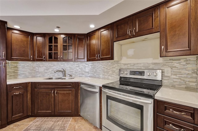 300 Three Islands Blvd Unit 518, Hallandale Beach, FL 33009 - kitchen featuring stainless steel appliances, light tile patterned flooring, light countertops, glass insert cabinets, and recessed lighting