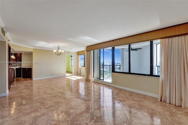 unfurnished room featuring a chandelier, baseboards, and ornamental molding