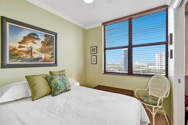 bedroom featuring ceiling fan and ornamental molding