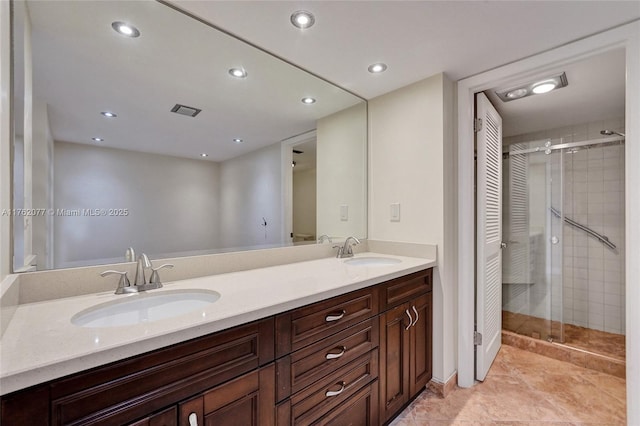 full bathroom with a sink, a stall shower, and double vanity