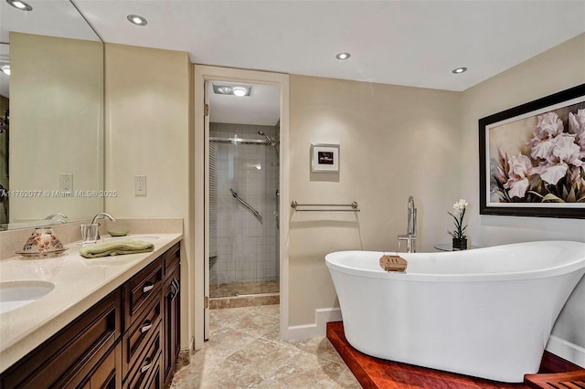 full bath featuring double vanity, a shower stall, a freestanding bath, and a sink