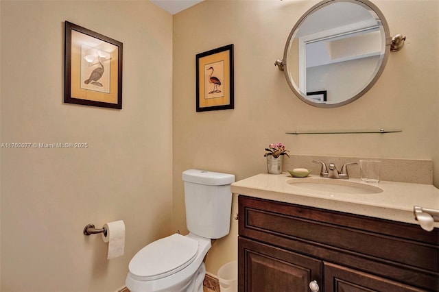 bathroom featuring toilet and vanity