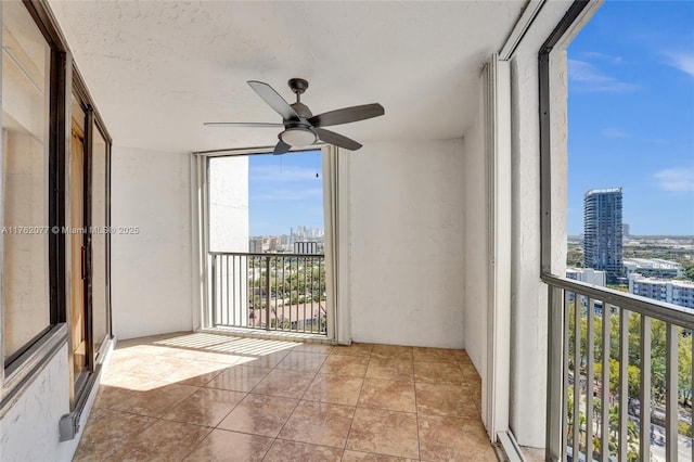 balcony featuring a view of city and ceiling fan