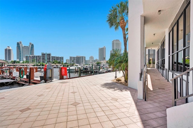 300 Three Islands Blvd Unit 518, Hallandale Beach, FL 33009 - view of patio featuring a skyline view, a water view, and a boat dock