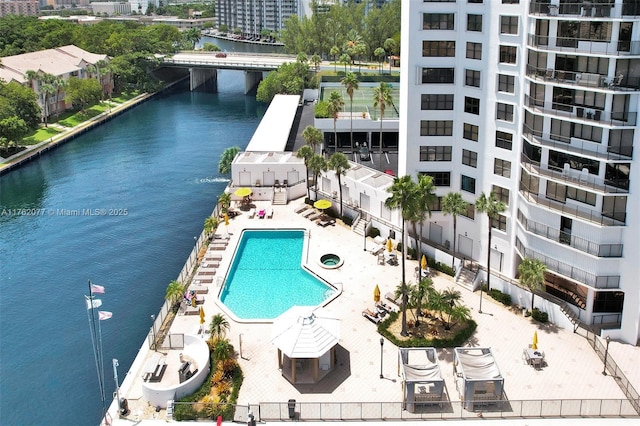 pool featuring a city view, a patio, and a water view