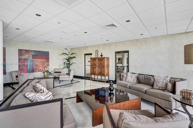 living room featuring visible vents and a paneled ceiling