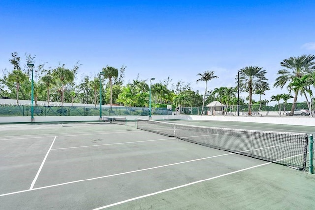 view of tennis court featuring fence