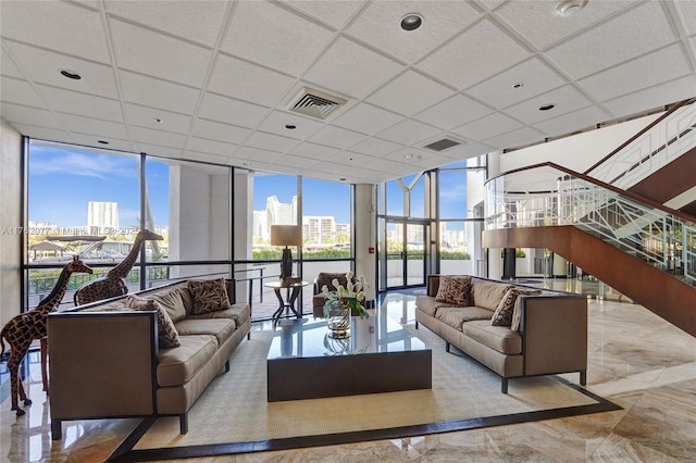 300 Three Islands Blvd Unit 518, Hallandale Beach, FL 33009 - living area featuring floor to ceiling windows, a city view, marble tiled floors, and a drop ceiling