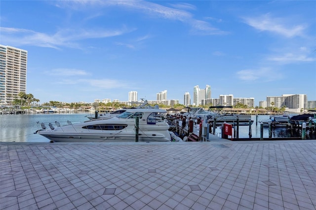 view of dock featuring a city view and a water view