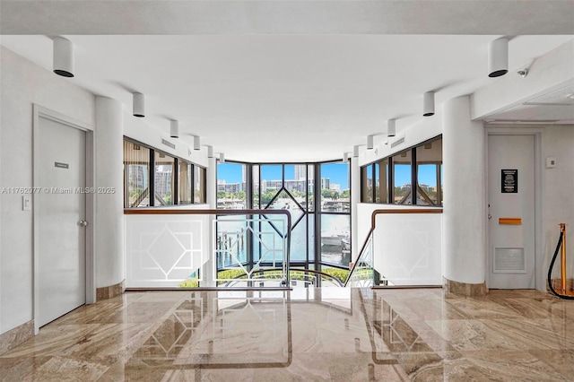 300 Three Islands Blvd Unit 518, Hallandale Beach, FL 33009 - hallway featuring marble tiled floors and floor to ceiling windows