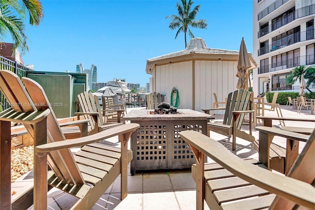 view of patio with a view of city and an outdoor fire pit