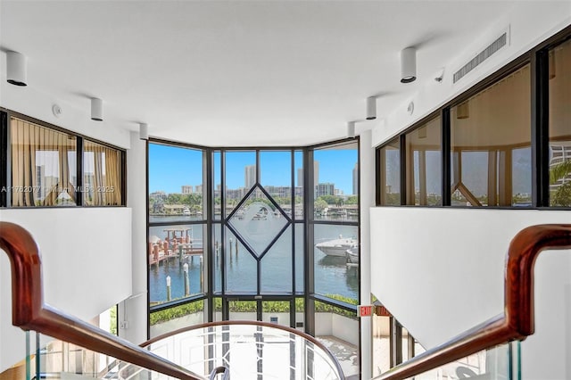 room details featuring visible vents, a water view, and a city view