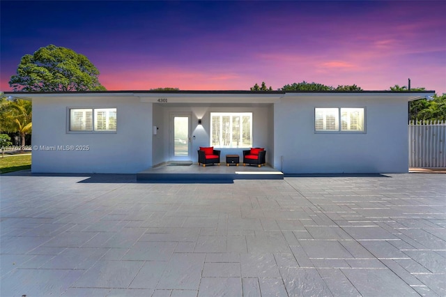 view of front of property featuring stucco siding and a carport