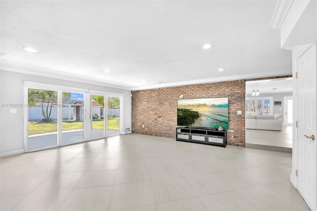 unfurnished living room featuring recessed lighting, plenty of natural light, brick wall, and ornamental molding