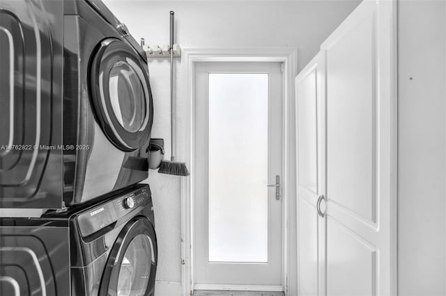 laundry room featuring laundry area and stacked washer and clothes dryer