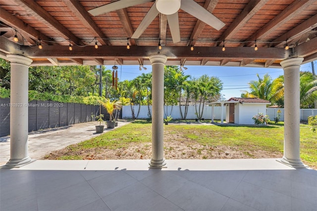 view of patio with an outbuilding and a fenced backyard