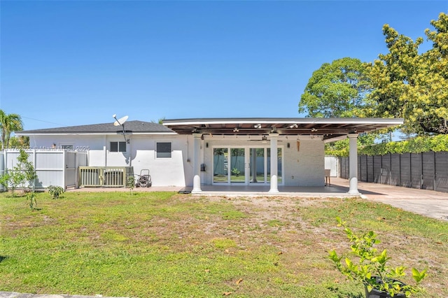 rear view of house with a patio area, a yard, and fence