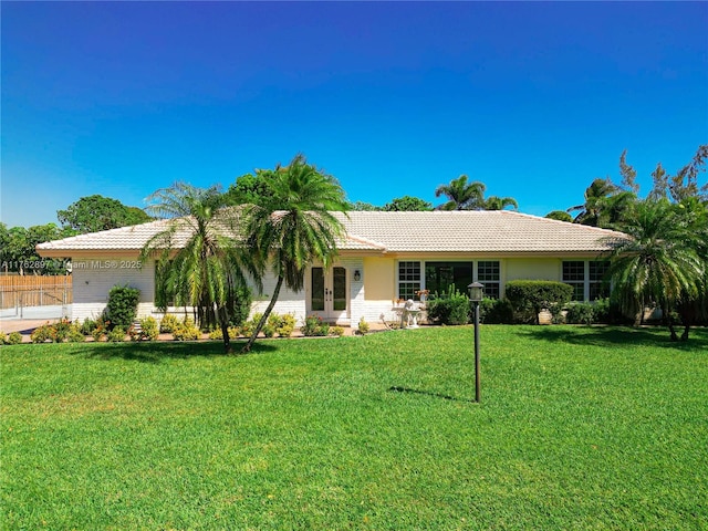 ranch-style house with a tiled roof and a front lawn