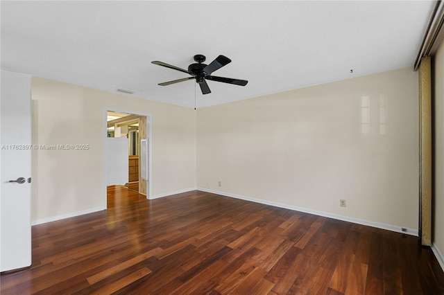 empty room with visible vents, a ceiling fan, baseboards, and wood finished floors