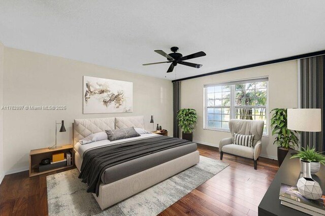 bedroom with wood finished floors, baseboards, and ceiling fan