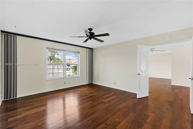 unfurnished room featuring baseboards, a ceiling fan, and wood finished floors