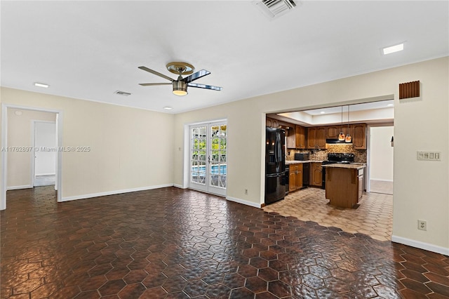 unfurnished living room with a ceiling fan, visible vents, french doors, and baseboards