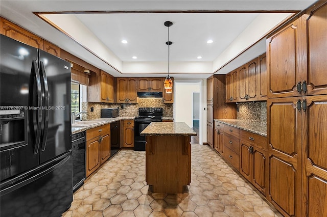 kitchen featuring black appliances, a sink, backsplash, a kitchen island, and exhaust hood