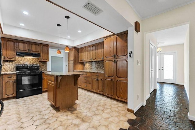 kitchen with visible vents, a center island, a tray ceiling, exhaust hood, and electric range