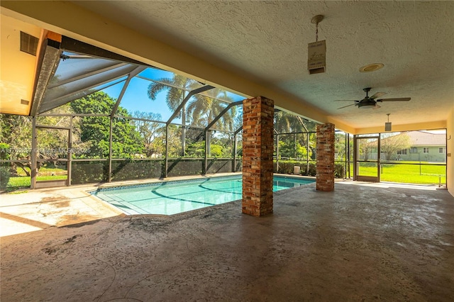 pool with a patio, a lanai, and a ceiling fan