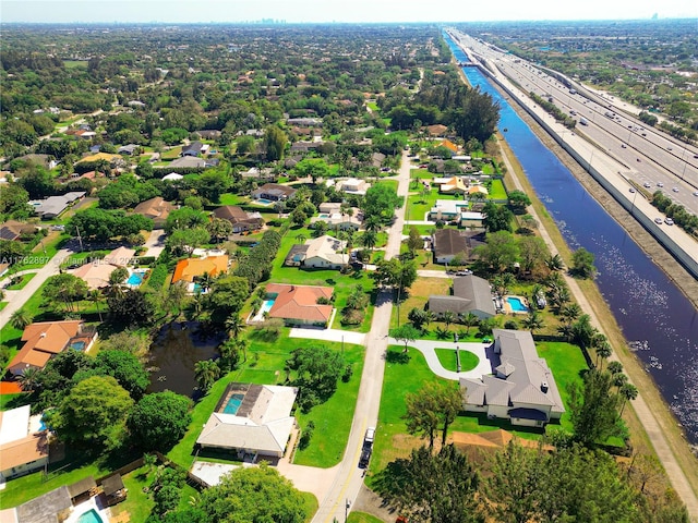 birds eye view of property with a water view and a residential view