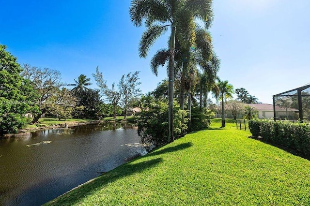 view of yard featuring a water view and a lanai