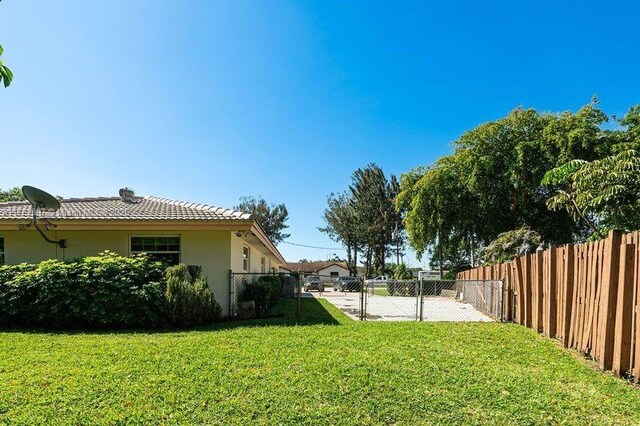 view of yard featuring a fenced backyard and a gate