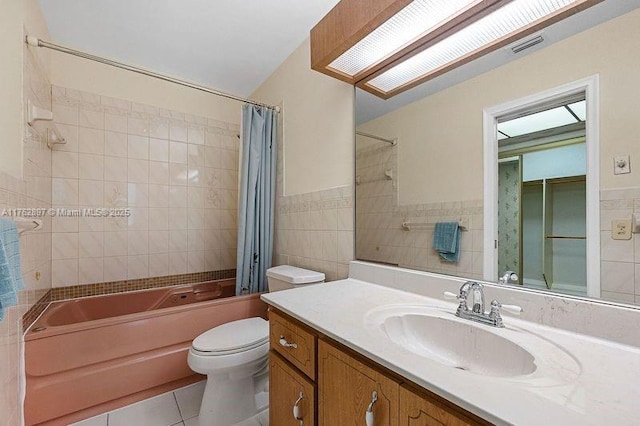 full bathroom featuring tile patterned flooring, tile walls, toilet, shower / tub combo, and vanity