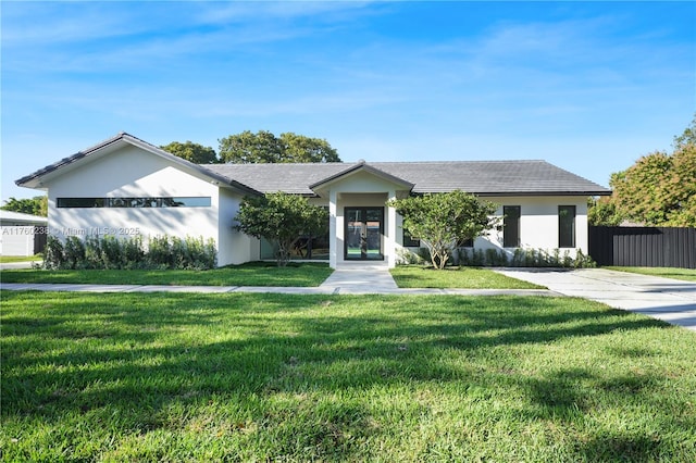 ranch-style home with a front yard, french doors, fence, and stucco siding