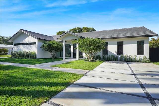 view of front of home with stucco siding and a front lawn