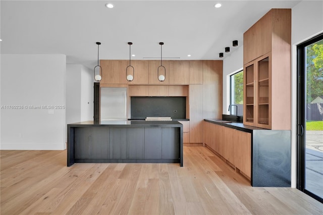 kitchen featuring light wood-style flooring, recessed lighting, built in fridge, dark countertops, and modern cabinets