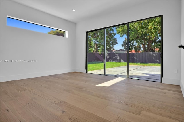 unfurnished room featuring recessed lighting, baseboards, and wood finished floors