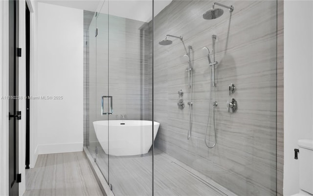 full bath featuring a soaking tub and a stall shower