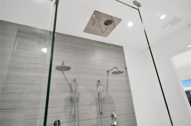 bathroom with recessed lighting, a marble finish shower, and visible vents